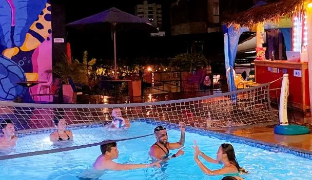 Where to Stay in San Gil, Colombia: Best Hostels, Hotels and Airbnbs (2026) pool and volleyball players at trip monkey origen hostel