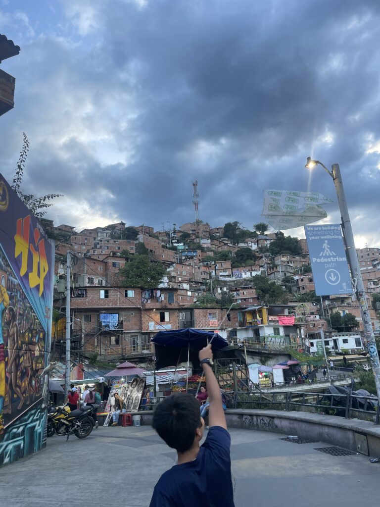 colombian child flying a kite in comuna 13, colombia