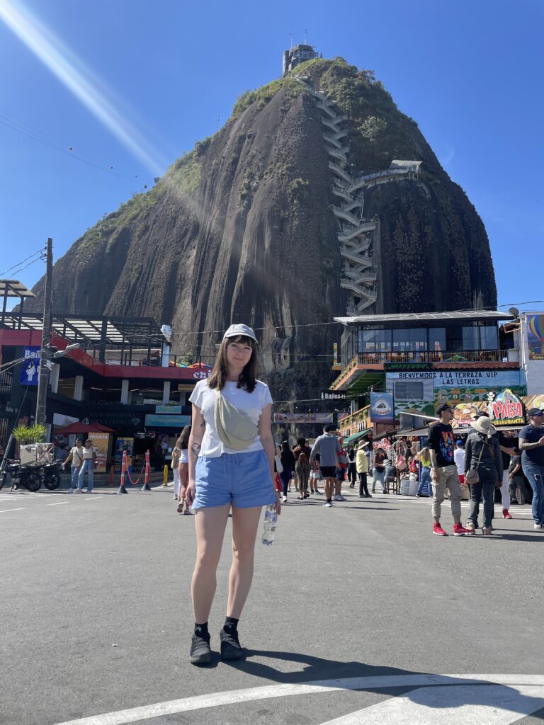Is Guatapé Worth It in 2026? My Honest Guatapé Day Trip Review me standing in front of piedra del penol in guatape colombia