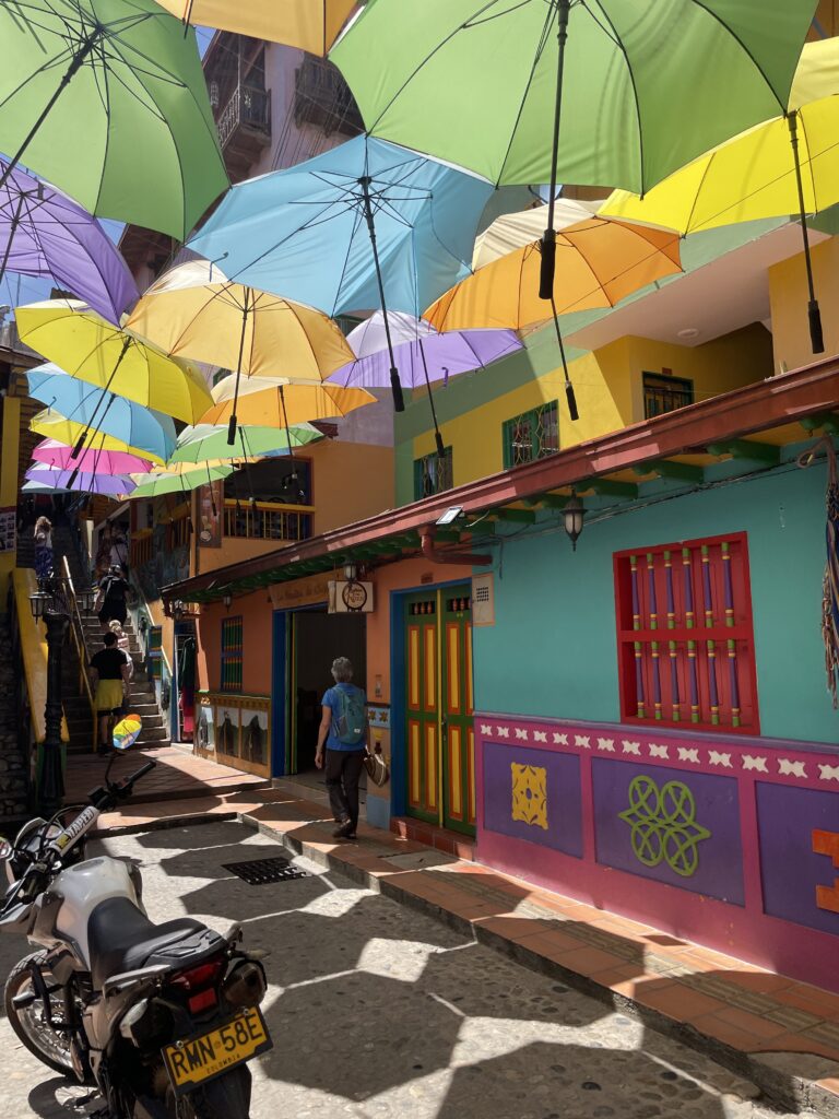 Is Guatapé Worth It in 2026? My Honest Guatapé Day Trip Review umbrella street in guatape colombia