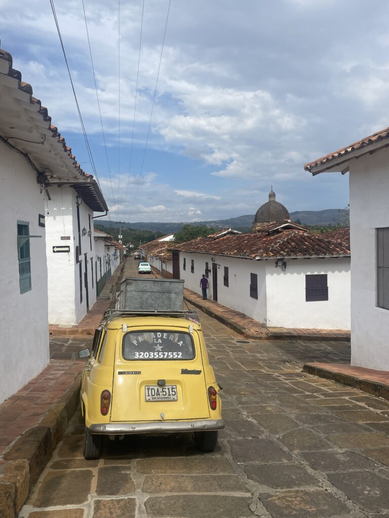 yellow car on a street in barichara colombia